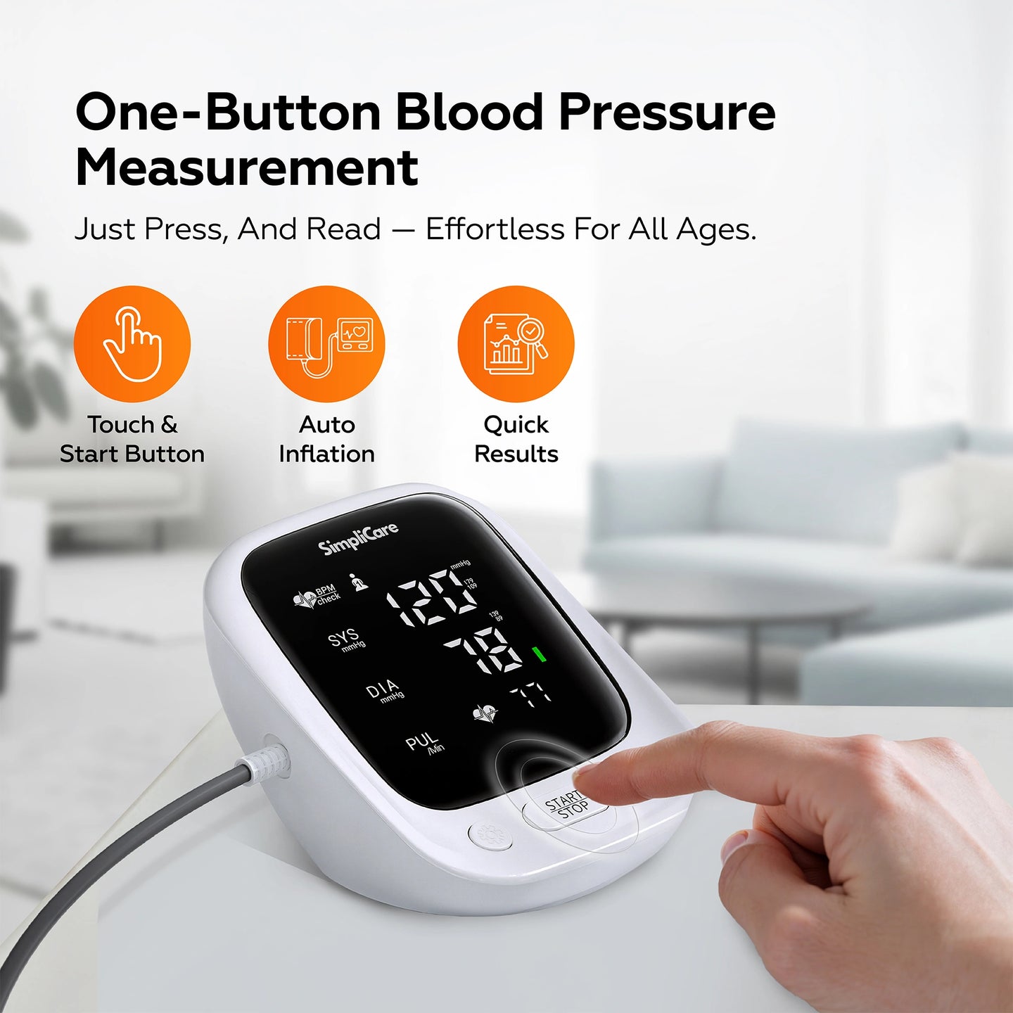 Blood pressure monitor with a hand using it, set against a blurred indoor background.